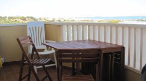 a wooden table and two chairs on a balcony at apartamento Cala Flores nº VV MU5868-1 in Cabo de Palos