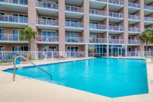 a swimming pool in front of a building at The Dunes #707 in Gulf Shores