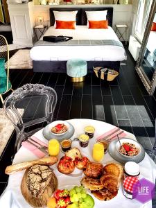 a tray of breakfast foods on a table in a hotel room at LIFE CATHEDRALE City-Center Place Gutenberg in Strasbourg