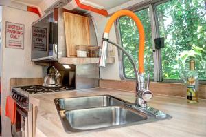 a kitchen with a sink and a stove at Glamping 1970 American Airstream motorhome in Ponsanooth