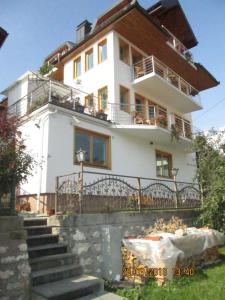 a white house with a table in front of it at Villa Una in Sarajevo