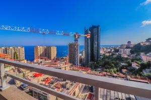 a view of a city with a crane at The Paradise Monac'Home Parking in Monte Carlo