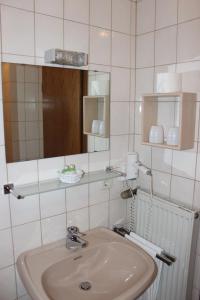 a bathroom with a sink and a mirror at Pfaelzer Stuben in Landstuhl
