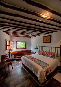 a bedroom with a large bed and a couch at Hotel Zentik Project & Saline Cave in Valladolid