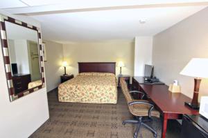 a hotel room with a bed and a desk at Knights Inn Pine Grove I-81 Exit 100 in Pine Grove