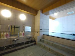 a bathroom with two sinks and a mirror at HOTEL ROUTE-INN Ueda - Route 18 - in Ueda