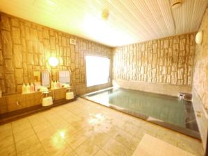 a swimming pool in a room with at Hotel Route-Inn Jouetsu in Joetsu