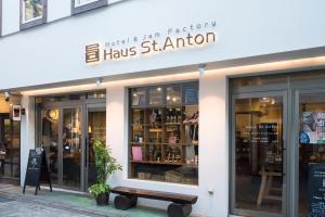 a store front with a bench in front of it at Hotel Haus St Anton in Nozawa Onsen