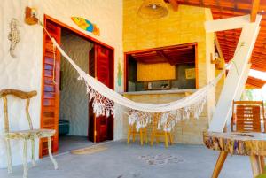 a room with a hammock in a house at Flats Macapá Meu Amor in Luis Correia