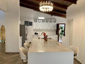 a kitchen with a large white island in a room at Palmira Hostel in Tegucigalpa