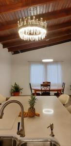 a kitchen counter with a sink and a chandelier at Palmira Hostel in Tegucigalpa +37 photos