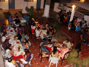 a group of people sitting at tables at a party at Eco Bay Hotel in Bahía Kino