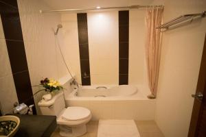 a bathroom with a toilet and a bath tub at Baan Boa Resort in Patong Beach