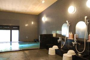 a bathroom with a shower and a swimming pool at Hotel Route-Inn Nagahama Inter in Nagahama