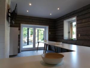a dining room with a table with two bowls on it at Villa Germaine in Stratendries