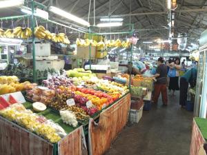 a market with a bunch of fruits and vegetables on display at Minima 8 in George Town