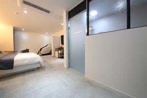 a bedroom with a bed and a sliding glass door at 2Night Business Hotel in Jeonju