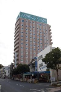 a large building with writing on the top of it at Hotel Route-Inn Tokuyama Ekimae in Shunan