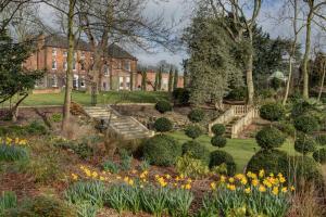 a garden with stairs and flowers in front of a house at Best Western Plus West Retford Hotel in Retford