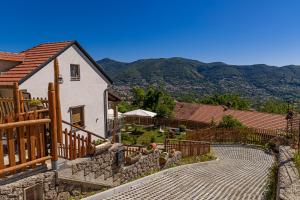 a house with a fence and a patio with a yard at B&B Villa Italia in Agerola
