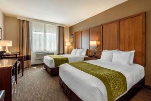 a hotel room with two beds and a window at Comfort Inn Ellsworth - Bar Harbor in Ellsworth