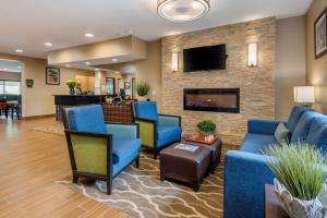 a living room filled with furniture and a fire place at Comfort Inn Ellsworth in Ellsworth