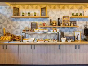a kitchen with a counter with food on it at ibis Lausanne Centre in Lausanne