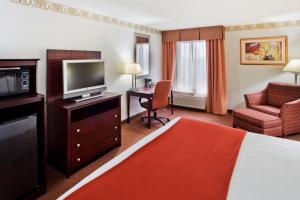 a hotel room with a bed and a flat screen tv at Holiday Inn Express Atlanta W (I-20) Douglasville, an IHG Hotel in Douglasville