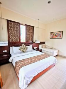 Postel nebo postele na pokoji v ubytování Yulia Village Inn Ubud
