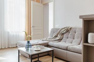 a living room with a couch and a table at Central Barkar Apartments in Odesa