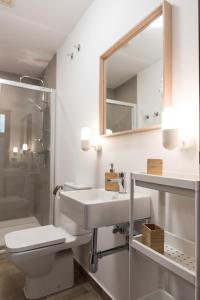 a bathroom with a sink and a toilet and a mirror at Apartamento Centro La Paz by CasaTuristica in Ronda