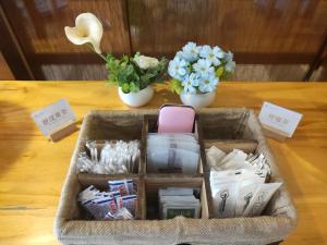 a basket filled with items on a table with flowers at lnsail Hotel Shenzhen Luohu Port Railway Station in Shenzhen