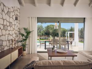a living room with a couch and a table at Gerakas Luxury Villas in Vasilikos