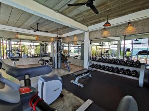 a gym with several rows of treadmills and machines at S Park Design Hotel in Vientiane