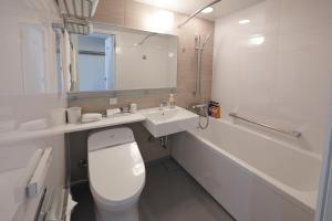 a bathroom with a white toilet and a sink at HOTEL VISCHIO AMAGASAKI by GRANVIA in Amagasaki