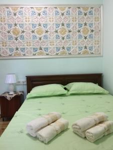 a bed with two towels on top of it at Munis in Samarkand