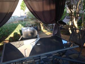a view of a glass table in a yard at Rez de Villa Pébrier in Fréjus