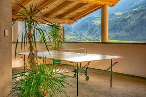 a table in a room with a view of a mountain at Landhaus Sonnblick in Zellberg