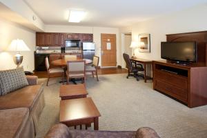 a living room with a couch and a dining room at Staybridge Suites Great Falls, an IHG Hotel in Great Falls