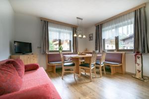 a living room with a dining room table and chairs at Appartmenthaus Martina in Zell am Ziller