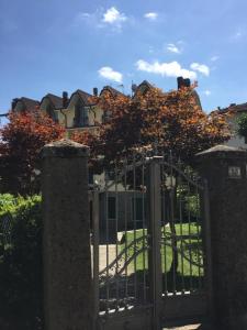 a gate in front of a house with trees at Casa Belvedere in Lizzano in Belvedere