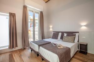 Katil atau katil-katil dalam bilik di Residenza Cavallini