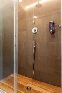 a shower with a glass door in a bathroom at Residenza Cavallini in Rome