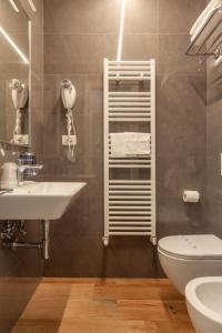 a bathroom with a sink and a toilet at Residenza Cavallini in Rome