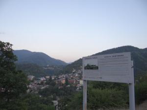 a sign on the side of a hill overlooking a city at Dalko in Borjomi