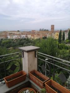 a balcony with two planters and a view of a city at Borgo Creativo in Montopoli in Val dʼArno