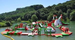 a water park with a bunch of water play equipment at Lake House St Pee Sur Nivelle in Saint-Pée-sur-Nivelle