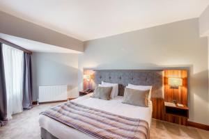 a hotel room with a large bed with two pillows at The Sign Esentepe Hotel&Kayak Merkezi in Gerede