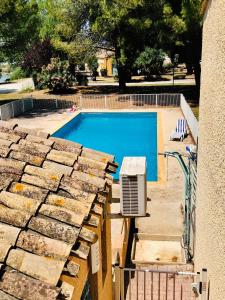 an overhead view of a swimming pool with a heater at Appartement 238 village LES SALICORNES in Arles
