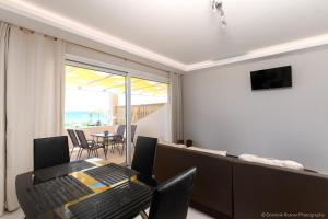 a dining room with a table and a view of the ocean at Seashore Stream Suites in Alykes